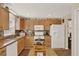 Bright kitchen featuring ample cabinet space, stainless island, and white appliances at 428 Lake Suzanne Dr, Lake Wales, FL 33859