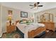 Spacious main bedroom with a ceiling fan, wood furniture and a carpet at 428 Lake Suzanne Dr, Lake Wales, FL 33859