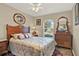 Comfortable main bedroom featuring wood furnishings and a window letting in natural light at 428 Lake Suzanne Dr, Lake Wales, FL 33859