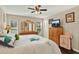 Bright main bedroom with ceiling fan, closet, and a dresser at 428 Lake Suzanne Dr, Lake Wales, FL 33859