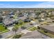 Aerial view of a residential neighborhood with houses and tree-lined streets at 452 Palastro Ave, Auburndale, FL 33823