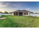 Spacious backyard with grassy area and screened porch at 452 Palastro Ave, Auburndale, FL 33823
