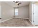 Simple bedroom with neutral walls, carpet flooring, and ceiling fan at 452 Palastro Ave, Auburndale, FL 33823