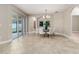 Bright dining room features a glass-top table with six chairs, and access to the kitchen at 452 Palastro Ave, Auburndale, FL 33823