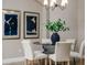Elegant dining room with a round table, six chairs, and modern art at 452 Palastro Ave, Auburndale, FL 33823