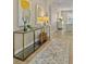 Elegant entryway with glass-top console table and patterned rug at 452 Palastro Ave, Auburndale, FL 33823
