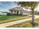 House exterior featuring a two-car garage and manicured lawn at 452 Palastro Ave, Auburndale, FL 33823