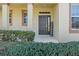 Inviting front entrance with a dark-colored door and lush landscaping at 452 Palastro Ave, Auburndale, FL 33823