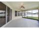 Bright screened porch with ceiling fan and view of backyard at 452 Palastro Ave, Auburndale, FL 33823