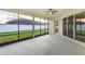 Relaxing screened porch with ceiling fan, sliding doors, and view of backyard at 452 Palastro Ave, Auburndale, FL 33823