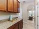Wet bar with granite countertop and wooden cabinets at 452 Palastro Ave, Auburndale, FL 33823
