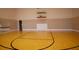 Community indoor basketball court featuring polished wooden floors and new basketball hoops at 4540 Turnberry Ln, Lake Wales, FL 33859