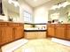 Bathroom featuring a soaking tub, and double vanities with oak cabinets at 4540 Turnberry Ln, Lake Wales, FL 33859