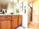 Bathroom showcasing a wood vanity, stone countertop, and glass enclosed shower at 4540 Turnberry Ln, Lake Wales, FL 33859
