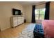 Bedroom with a flat-screen TV mounted above a white dresser, enhancing entertainment and storage at 4540 Turnberry Ln, Lake Wales, FL 33859