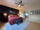 Bedroom showcasing a king bed, accent wall, and a glimpse into the ensuite bath at 4540 Turnberry Ln, Lake Wales, FL 33859