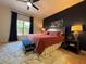 Cozy bedroom featuring a ceiling fan, neutral walls, and ample natural light from the window at 4540 Turnberry Ln, Lake Wales, FL 33859