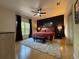 Spacious bedroom featuring a ceiling fan, wooden floors and a navy blue accent wall at 4540 Turnberry Ln, Lake Wales, FL 33859