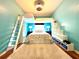 Bedroom with loft bed, white ladder, shelving, and blue accent walls at 4540 Turnberry Ln, Lake Wales, FL 33859