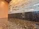 Close up of a speckled brown granite countertop and mosaic backsplash at 4540 Turnberry Ln, Lake Wales, FL 33859
