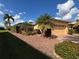 Well-maintained home exterior featuring lush landscaping, a paved driveway, and a two-car garage at 4540 Turnberry Ln, Lake Wales, FL 33859