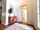 Hallway with wood floors featuring a stylish sideboard and access to a bathroom with classic fixtures at 4540 Turnberry Ln, Lake Wales, FL 33859