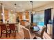 Open kitchen and breakfast nook with granite countertops and stainless steel appliances overlooking the pool at 4540 Turnberry Ln, Lake Wales, FL 33859