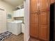 Convenient laundry room equipped with a washer, dryer, cabinets, and counter space at 4540 Turnberry Ln, Lake Wales, FL 33859