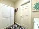 The laundry room boasts extra storage with white cabinets above a blue patterned rug at 4540 Turnberry Ln, Lake Wales, FL 33859