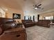 Comfortable living room featuring leather furniture, a ceiling fan, and an open floor plan at 4540 Turnberry Ln, Lake Wales, FL 33859
