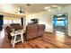 Inviting living room with a ceiling fan, wood floors, and brown leather sofas at 4540 Turnberry Ln, Lake Wales, FL 33859