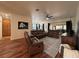 Spacious living room showcasing leather sofas, a ceiling fan, and access to outdoor space at 4540 Turnberry Ln, Lake Wales, FL 33859