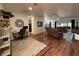 Open-concept living room featuring wood floors, modern decor, and comfortable leather seating at 4540 Turnberry Ln, Lake Wales, FL 33859