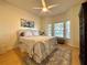 Bright main bedroom with a ceiling fan, bay windows, and a decorative rug on the floor at 4540 Turnberry Ln, Lake Wales, FL 33859