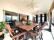 Enclosed patio space with ceiling fans and outdoor dining set and view to the kitchen at 4540 Turnberry Ln, Lake Wales, FL 33859