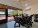 Enclosed patio featuring a wooden dining set and views of landscaped yard at 4540 Turnberry Ln, Lake Wales, FL 33859