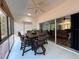 Enclosed patio featuring a wooden dining set and view of an adjacent living room at 4540 Turnberry Ln, Lake Wales, FL 33859