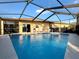 Sparkling screened-in pool with ample seating and sunny sky views, perfect for outdoor relaxation at 4540 Turnberry Ln, Lake Wales, FL 33859