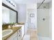 Bathroom featuring double sinks, framed mirror, and a shower-tub combination, offering a functional and well-lit space at 4639 Great Blue Heron Dr, Lakeland, FL 33812