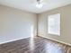 A simple, yet stylish bedroom featuring hard wood floors and a window that offers natural light at 4639 Great Blue Heron Dr, Lakeland, FL 33812