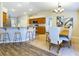 Kitchen featuring wooden cabinets and breakfast bar open to the dining room at 4639 Great Blue Heron Dr, Lakeland, FL 33812