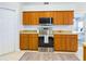 Kitchen with stainless steel appliances, oak cabinets and tiled floor at 4639 Great Blue Heron Dr, Lakeland, FL 33812