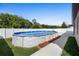 An open backyard with above ground pool and a lush green space, great for outdoor activities at 4924 Saint James St, Winter Haven, FL 33881