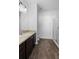 This bathroom features dark cabinetry, a white sink, and a glass-enclosed shower at 4924 Saint James St, Winter Haven, FL 33881