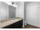 Bathroom features a vanity with dark cabinets and a tiled shower at 4924 Saint James St, Winter Haven, FL 33881