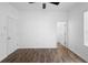 Bright bedroom boasts hardwood floors and a ceiling fan for comfortable living at 4924 Saint James St, Winter Haven, FL 33881