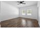 Spacious bedroom with hardwood floors, ceiling fan, and natural light at 4924 Saint James St, Winter Haven, FL 33881