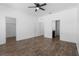 This bedroom has hardwood floors, a ceiling fan, and two doorways at 4924 Saint James St, Winter Haven, FL 33881