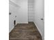 A walk-in closet with shelves and wood-look flooring at 4924 Saint James St, Winter Haven, FL 33881