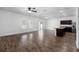 Spacious living room with wood flooring and a kitchen view, illuminated by natural light at 4924 Saint James St, Winter Haven, FL 33881